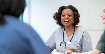 A doctor talking and laughing with her colleagues